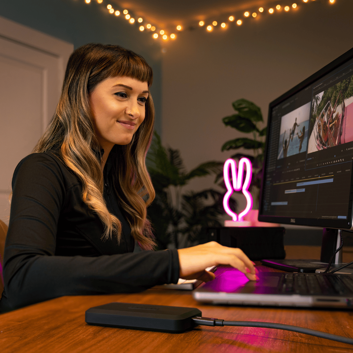 content creator working at her desk on her computer with a glyph drive 