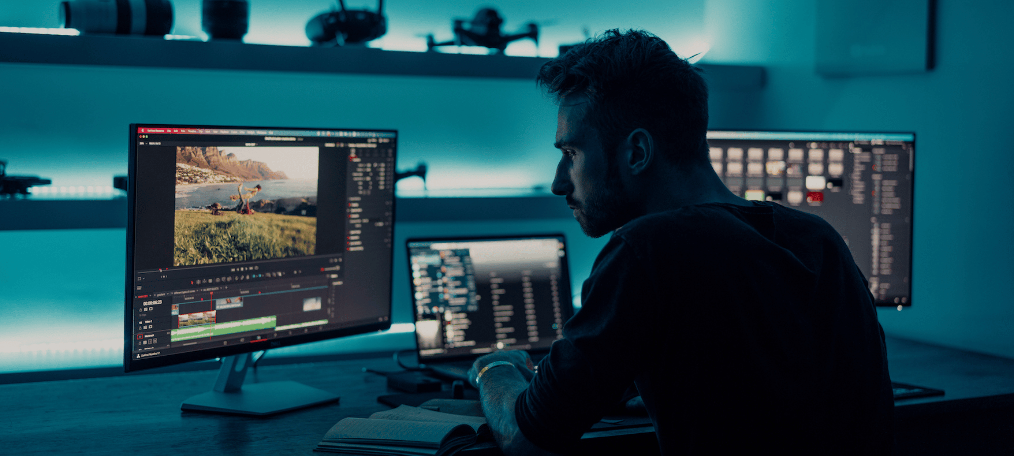 man working with multiple computer screens on his desk